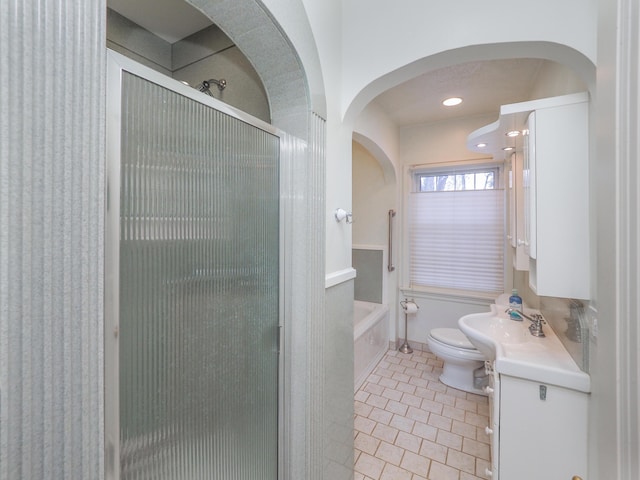 bathroom with tile patterned floors, vanity, toilet, and an enclosed shower