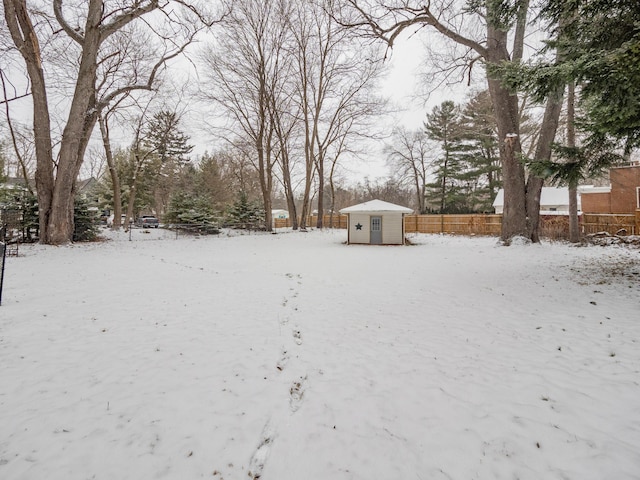 snowy yard with an outbuilding