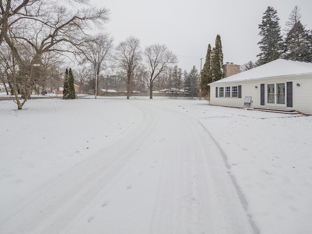 yard covered in snow with french doors