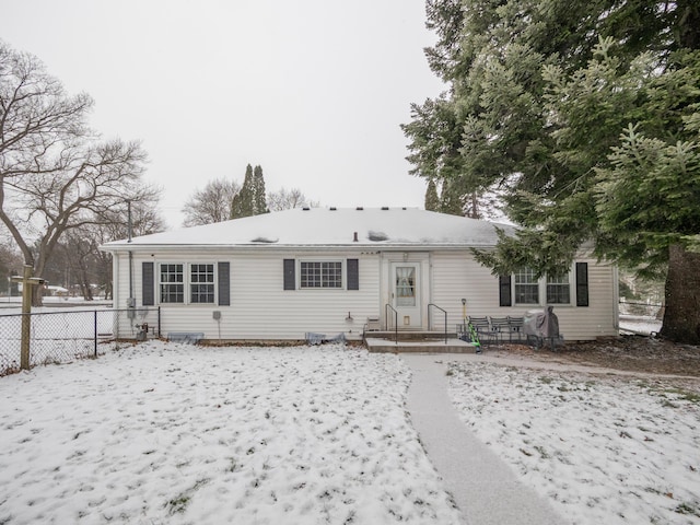 view of snow covered rear of property