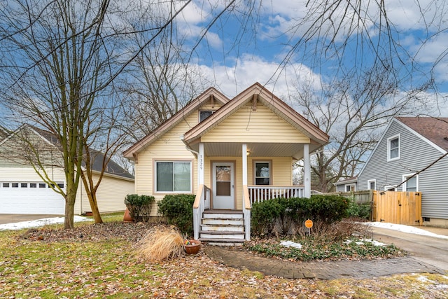 bungalow-style home with a garage and covered porch