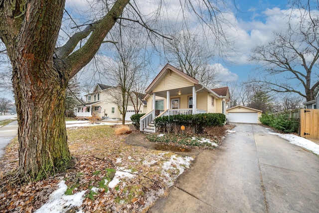 view of front of home with a porch, a garage, and an outdoor structure