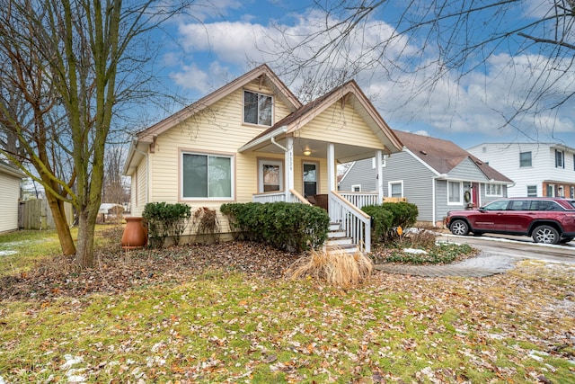 bungalow with a front yard and a porch