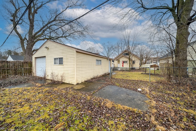 exterior space featuring a garage and an outdoor structure