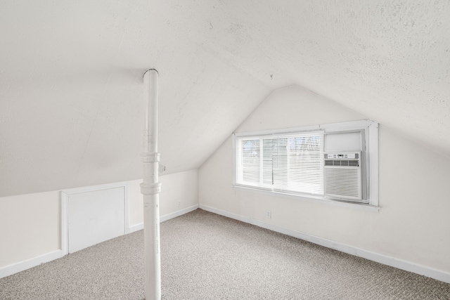 bonus room with carpet flooring, vaulted ceiling, and a textured ceiling