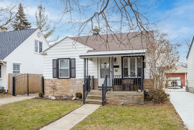 view of front of home featuring covered porch and a front yard