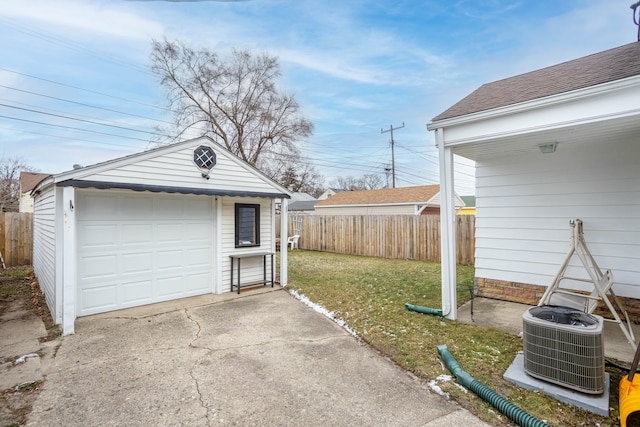 garage with a lawn and central AC