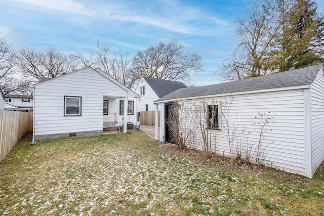 rear view of house featuring a lawn