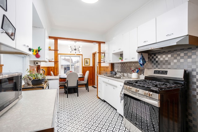 kitchen featuring white cabinetry, sink, a chandelier, and appliances with stainless steel finishes