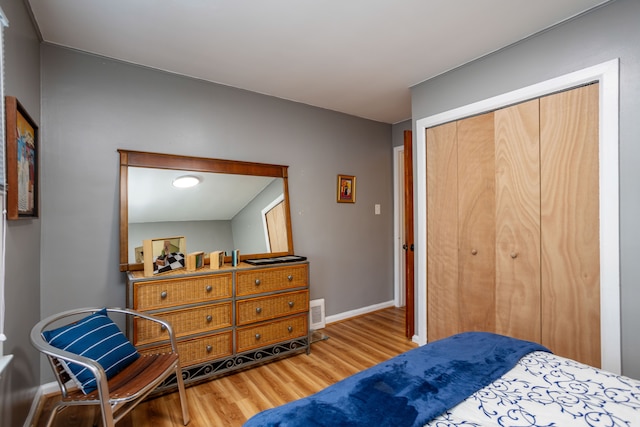 bedroom with hardwood / wood-style floors and a closet