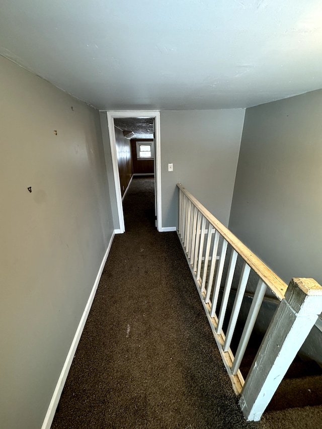 corridor with dark colored carpet