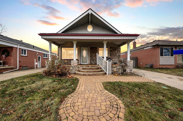 view of front facade featuring a lawn and a porch