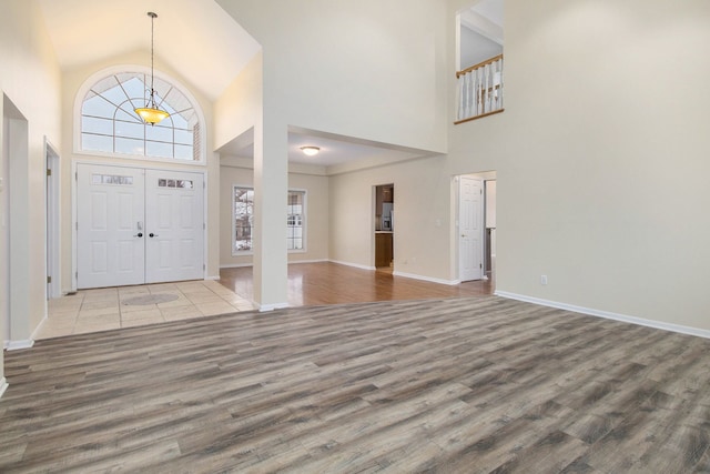 16073 Silverwood Dr, Fenton, MI 48430 - entrance foyer with baseboards, high vaulted ceiling, and wood finished floors