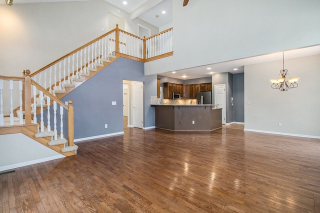 16073 Silverwood Dr, Fenton, MI 48430 - unfurnished living room featuring visible vents, stairway, baseboards, dark wood-style floors, and a notable chandelier