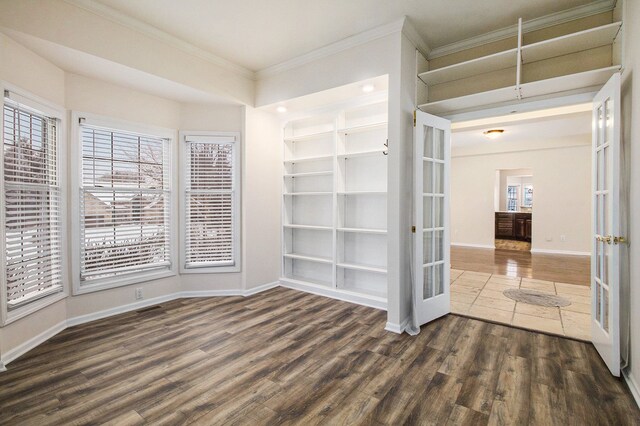 unfurnished room with dark hardwood / wood-style flooring, ornamental molding, and french doors