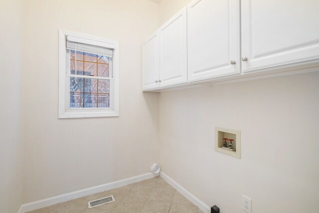 clothes washing area with hookup for a washing machine and cabinets