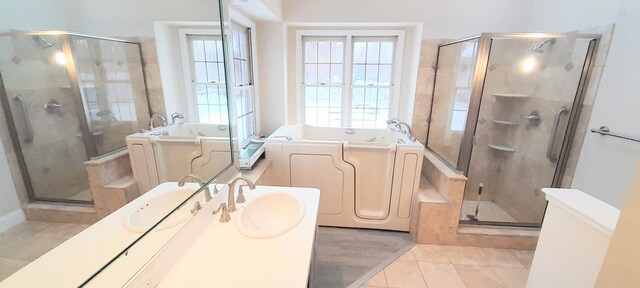 bathroom with tile patterned floors, washer / dryer, vanity, and plus walk in shower