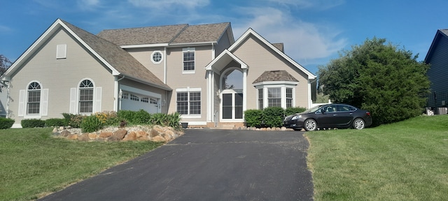 16073 Silverwood Dr, Fenton, MI 48430 - traditional home with a chimney, a garage, a front yard, and driveway