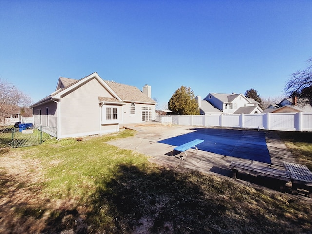 16073 Silverwood Dr, Fenton, MI 48430 - view of swimming pool with a patio, a yard, a fenced backyard, and a gate