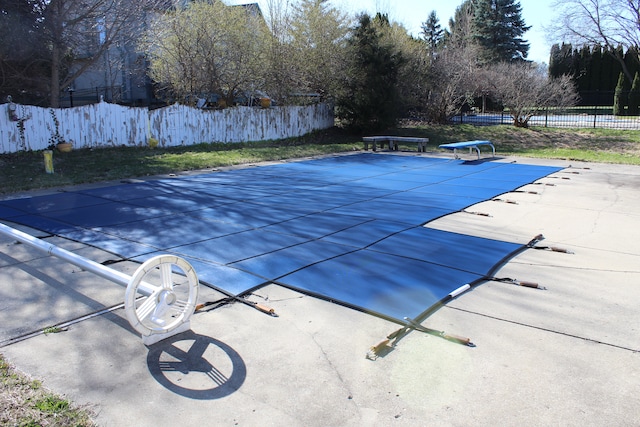 16073 Silverwood Dr, Fenton, MI 48430 - view of pool featuring a patio area, fence, a fenced in pool, and a diving board