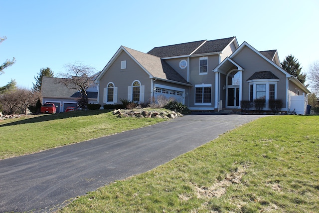 16073 Silverwood Dr, Fenton, MI 48430 - traditional-style house with a front yard, a garage, and driveway