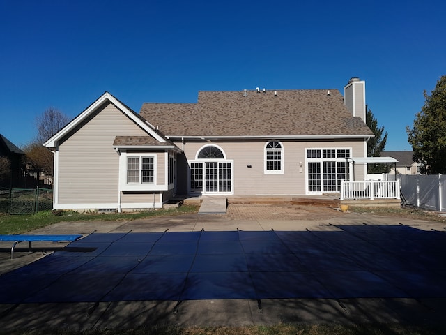 16073 Silverwood Dr, Fenton, MI 48430 - rear view of house featuring a fenced in pool, a patio, fence, and a chimney