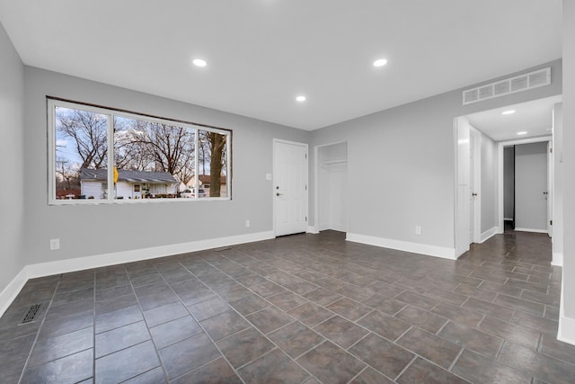 spare room featuring dark tile patterned flooring