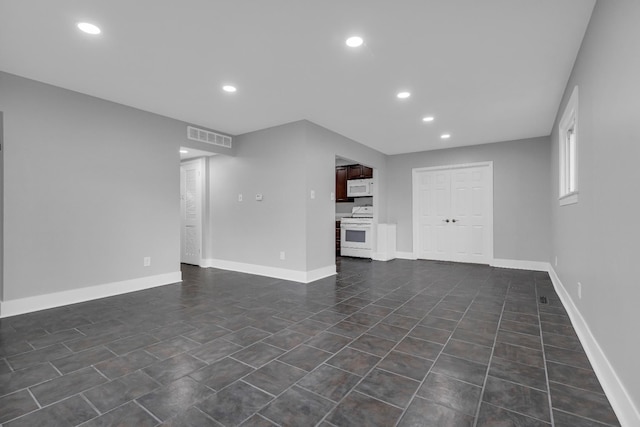 unfurnished living room featuring dark tile patterned flooring