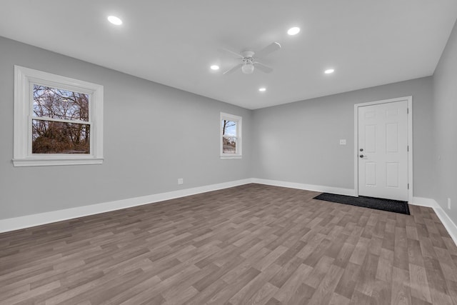 unfurnished room with ceiling fan and light wood-type flooring