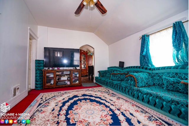 living room featuring vaulted ceiling, ceiling fan, and carpet