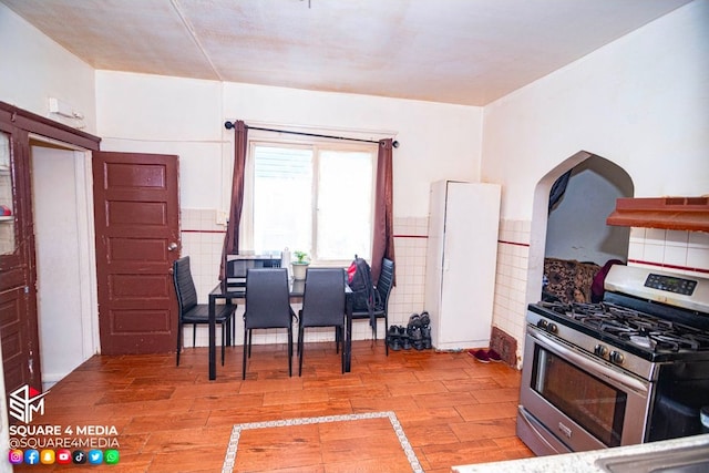 kitchen with ventilation hood and stainless steel gas stove