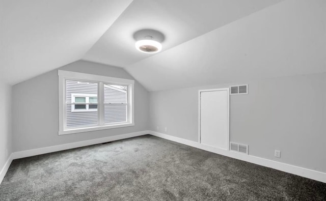 additional living space with carpet flooring and vaulted ceiling