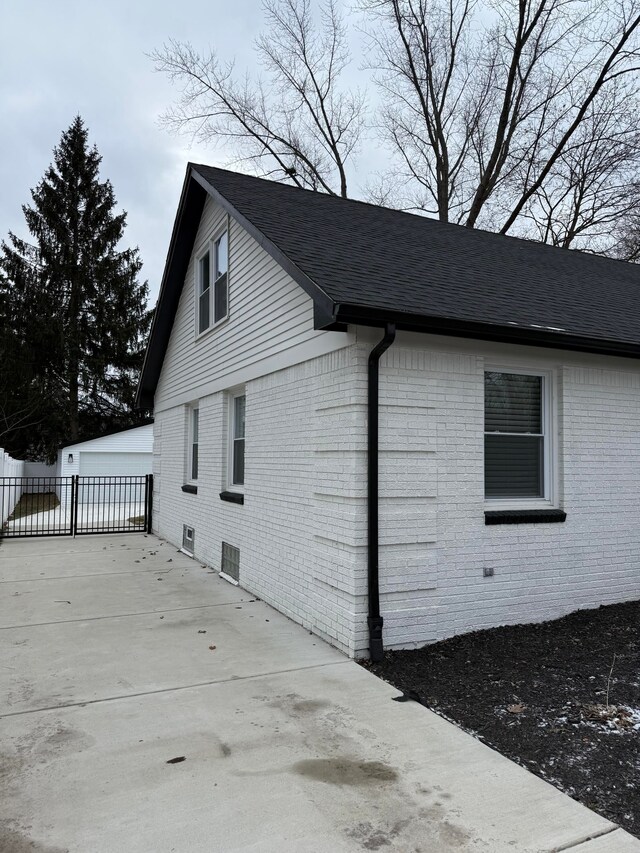 view of side of property featuring a garage and an outbuilding