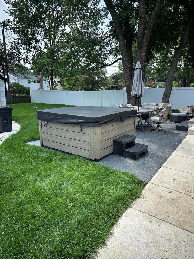 view of yard featuring a patio and a hot tub