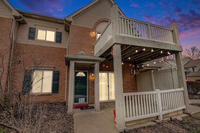 view of front of property featuring a balcony and a porch