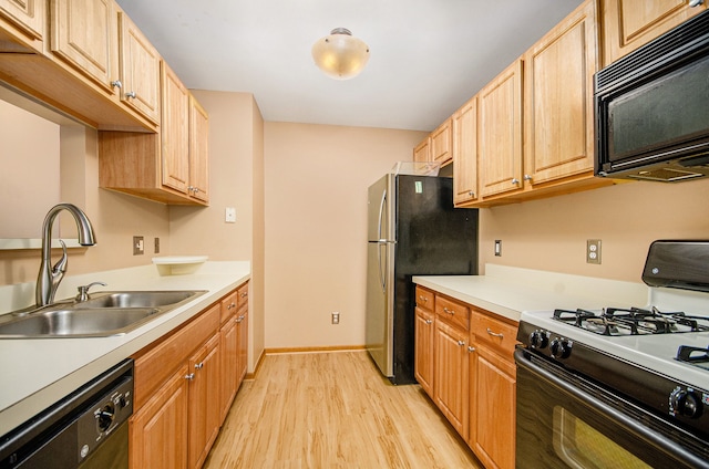 kitchen featuring sink, light hardwood / wood-style flooring, stainless steel fridge, dishwashing machine, and white range with gas stovetop