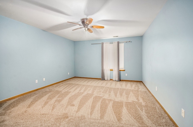 spare room with light colored carpet and ceiling fan