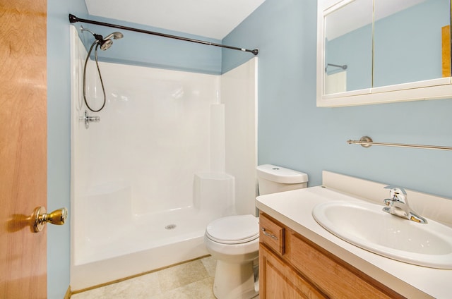 bathroom featuring walk in shower, vanity, and toilet