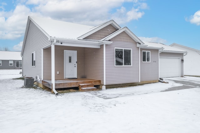 view of front of house with central AC and a garage