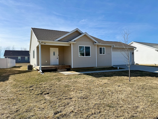 view of front facade featuring cooling unit, an attached garage, driveway, and a front lawn