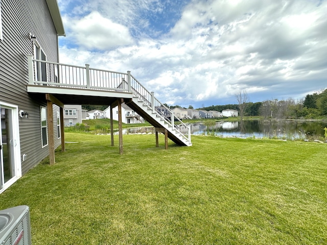 view of yard featuring cooling unit and a water view