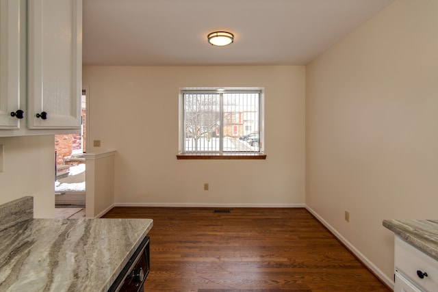 unfurnished dining area with dark hardwood / wood-style flooring