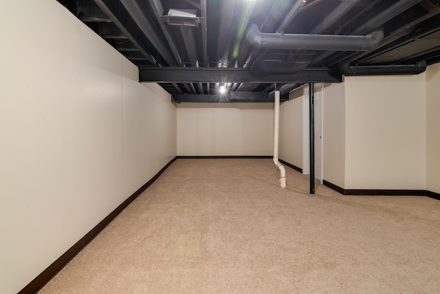 basement featuring light colored carpet