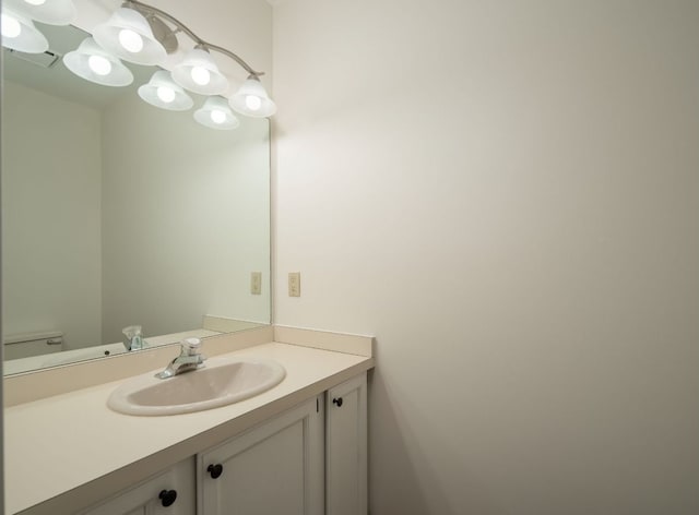 half bathroom with toilet and vanity