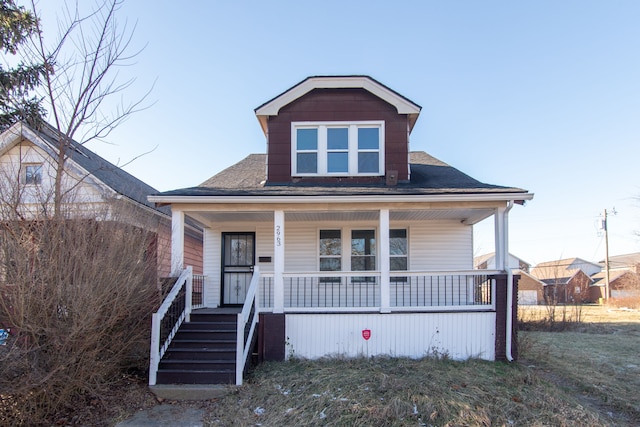 bungalow-style home featuring a porch and a front yard