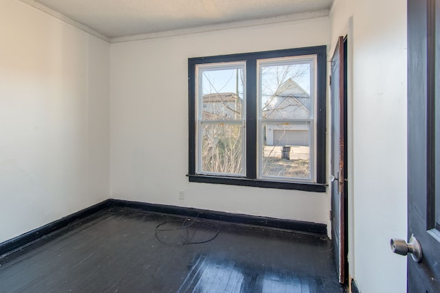 spare room with crown molding and dark hardwood / wood-style flooring