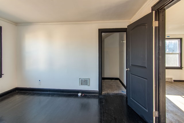 spare room with crown molding and dark hardwood / wood-style floors