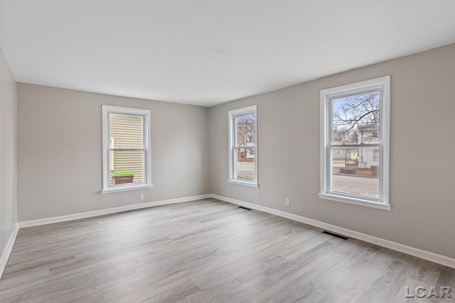 unfurnished room with light hardwood / wood-style flooring