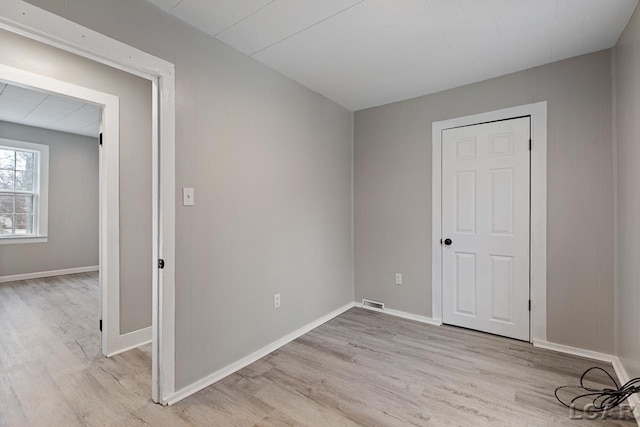 empty room with light hardwood / wood-style flooring