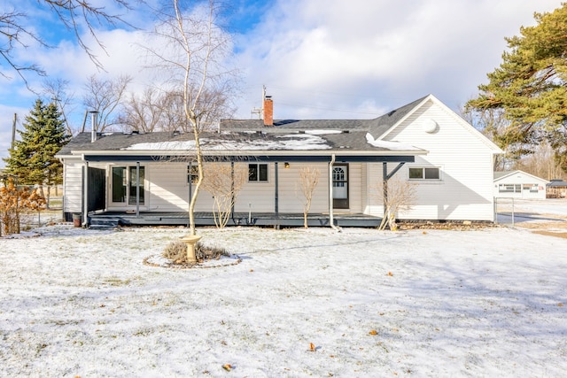 snow covered house with covered porch